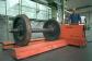 The forks of this manually controlled roll transporter are adjustable and have lifting flaps for lifting the load.